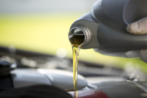 Fresh oil pouring into a car engine during a service